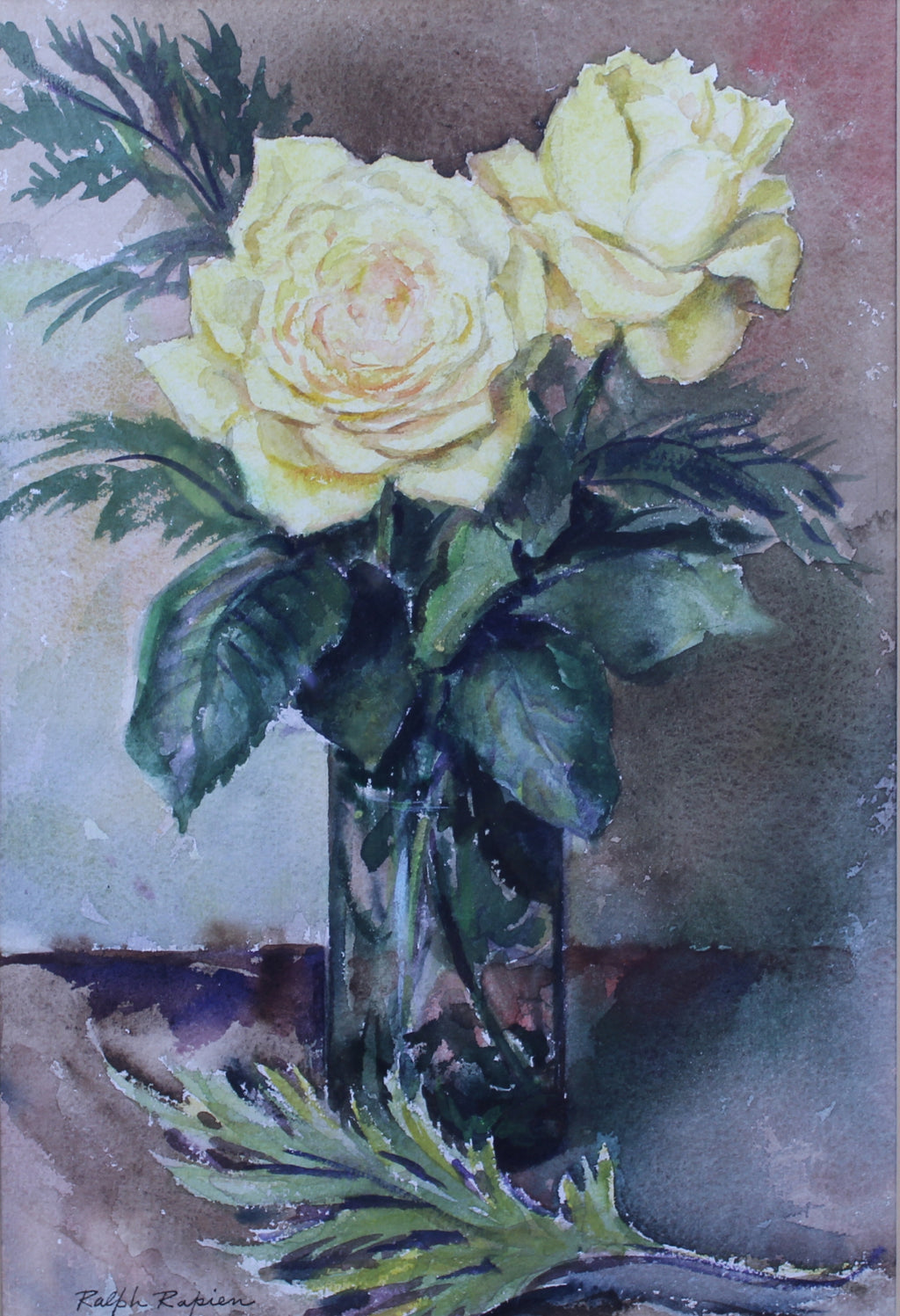 yellow roses in glass vase on table